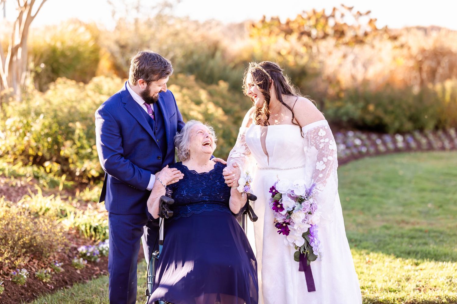 Joyful outdoor wedding portrait with couple and guest sharing a special moment.