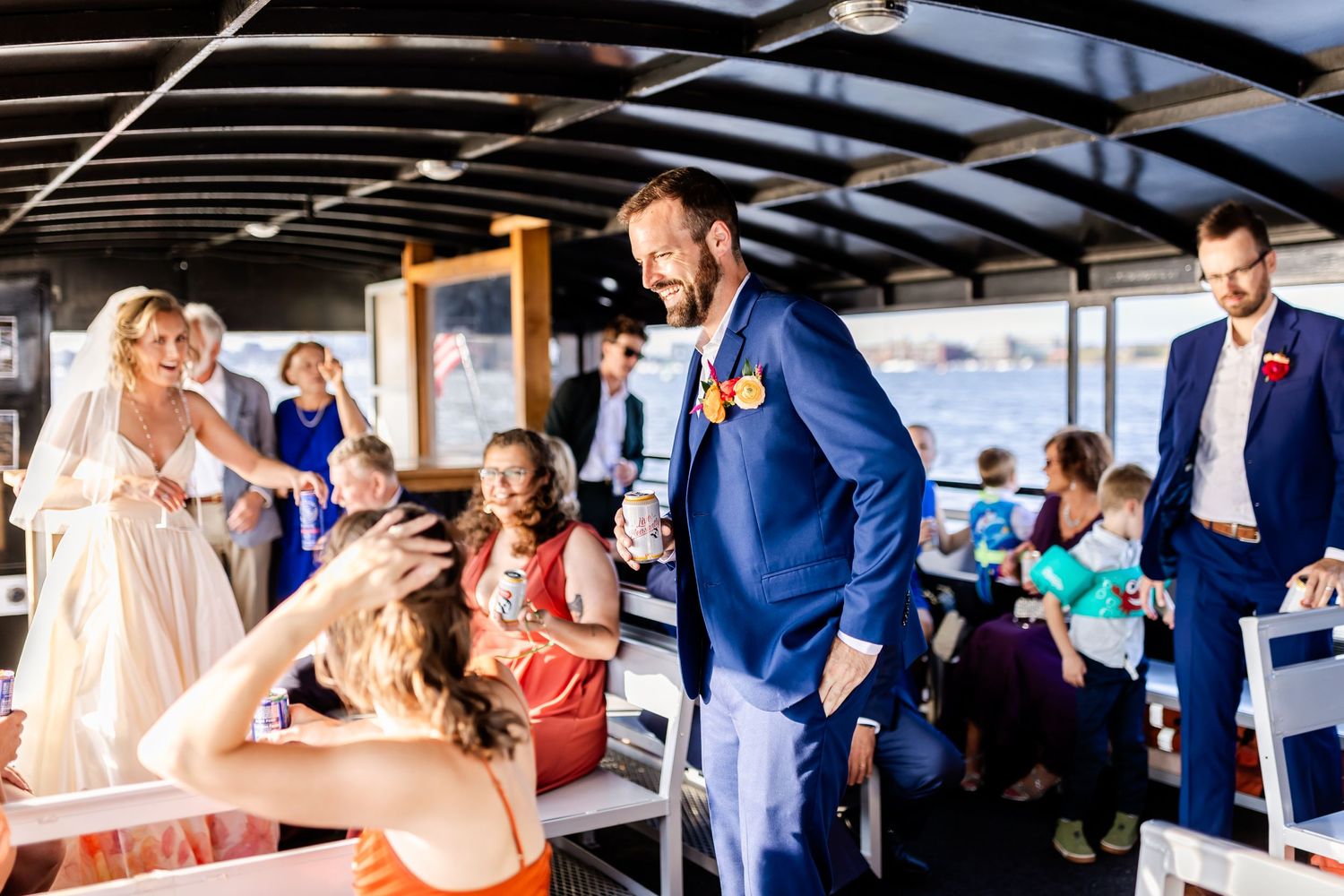 Wedding celebration on boat deck with festive atmosphere and guests.