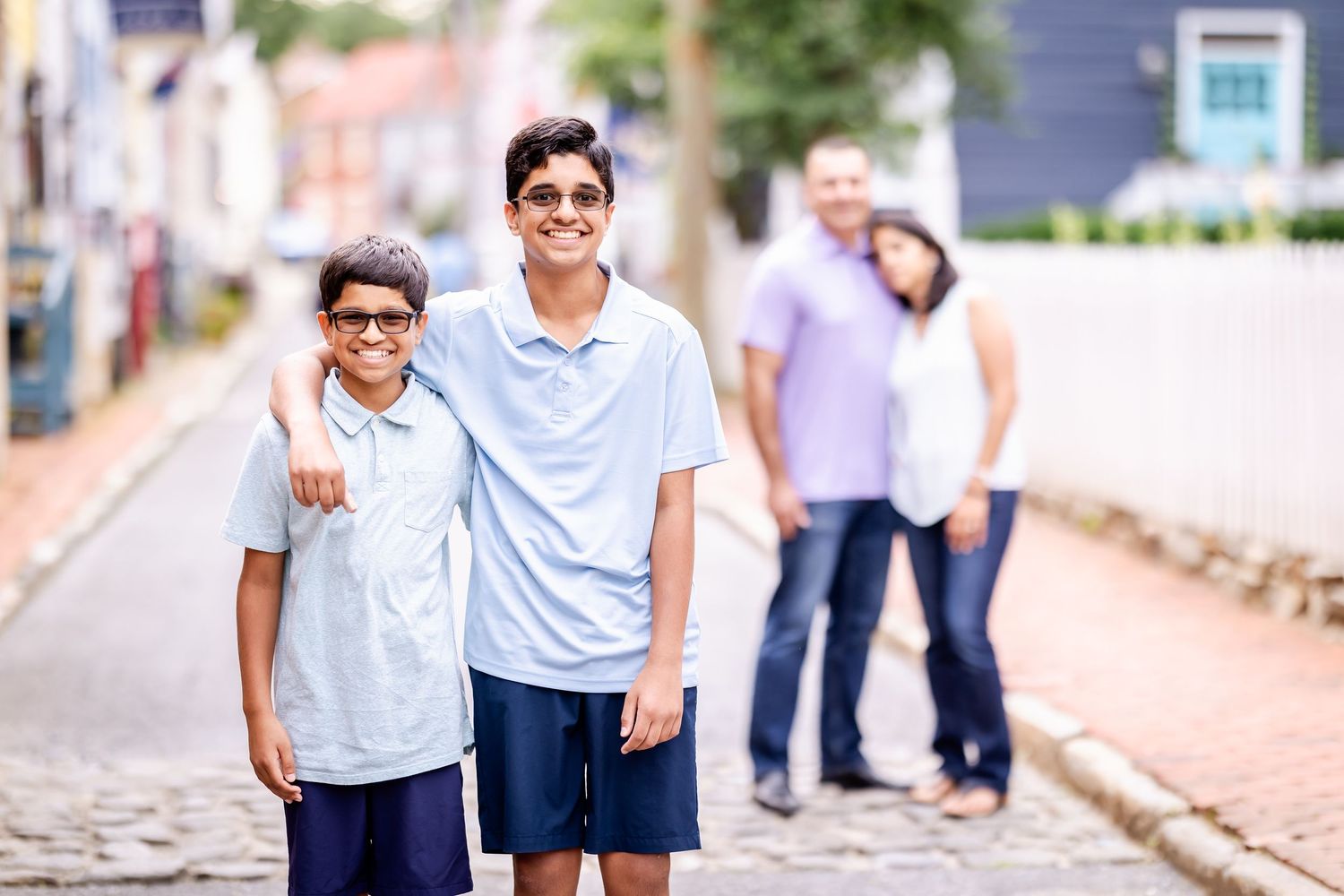 Students in light blue and white uniforms walk together outside on a sunny day.