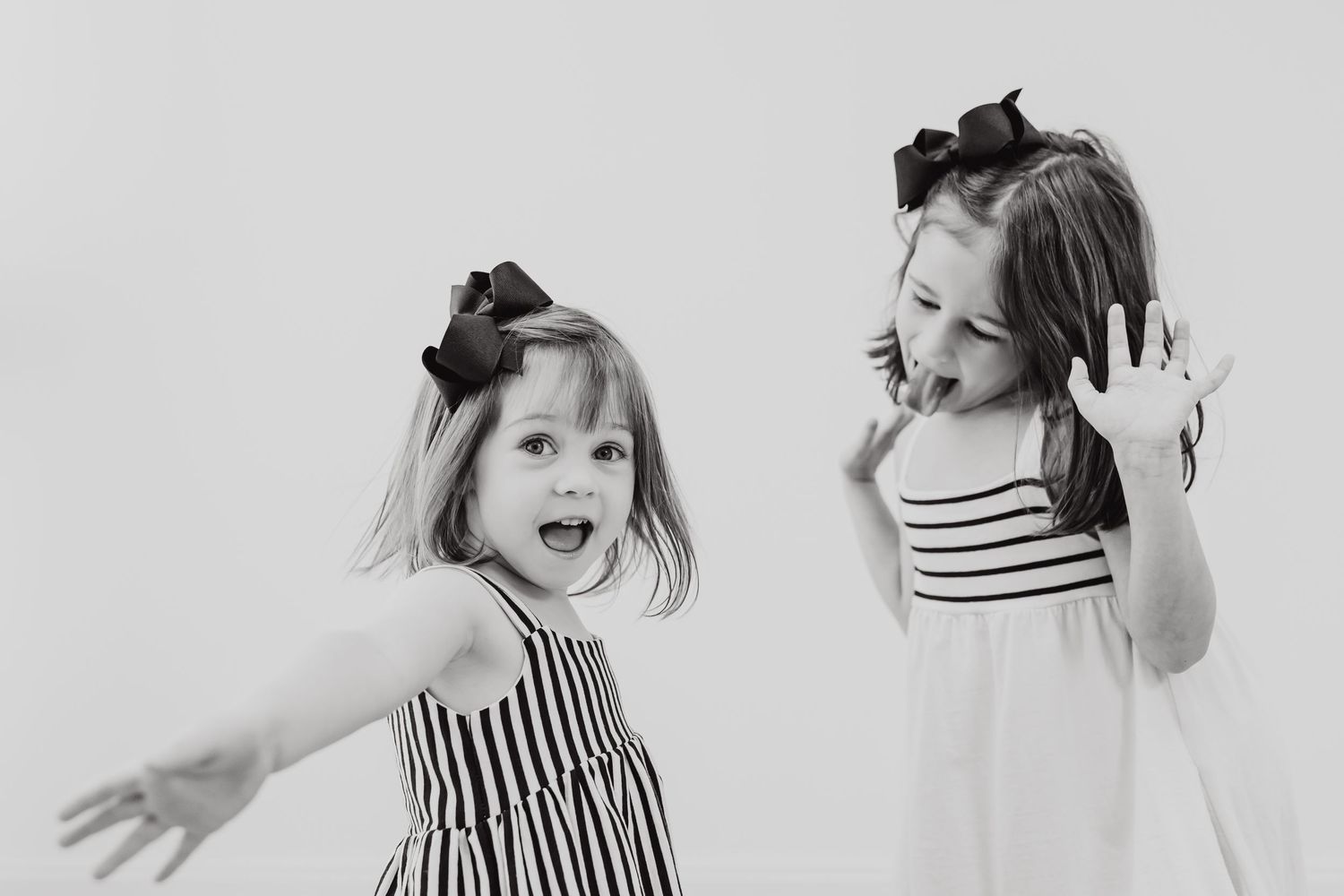 A black and white photo collage shows someone wearing a striped dress in various playful and expressive poses.