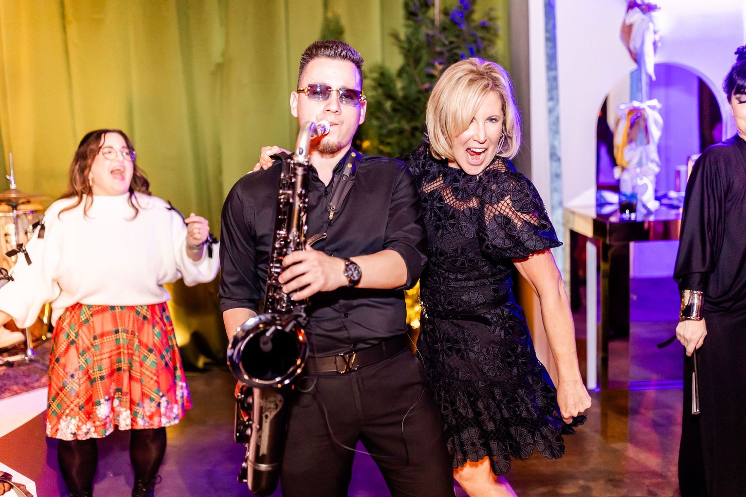 Lively wedding reception with musicians and guests enjoying the celebration.