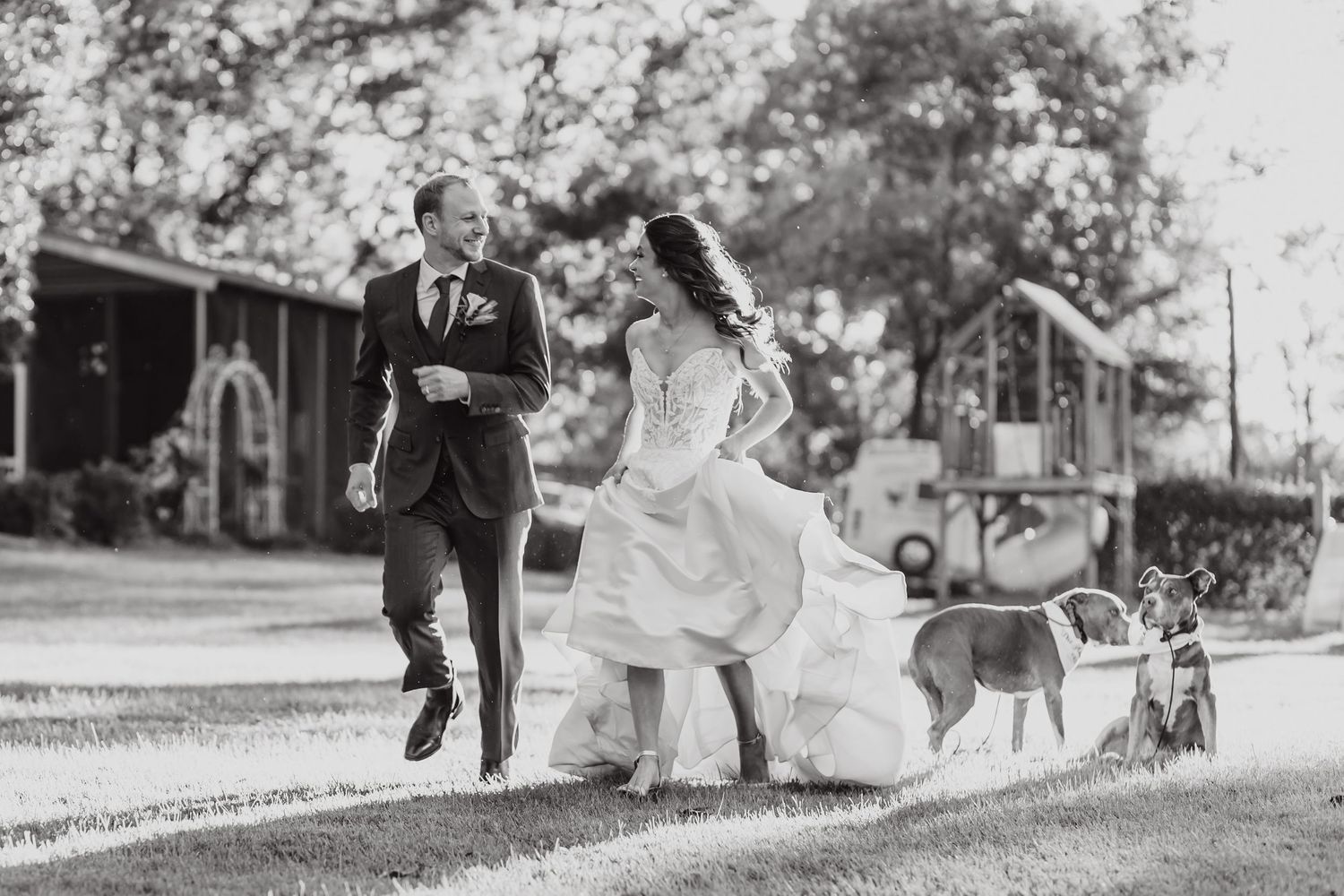 Black and white photo series captures a couple walking playfully through a park.