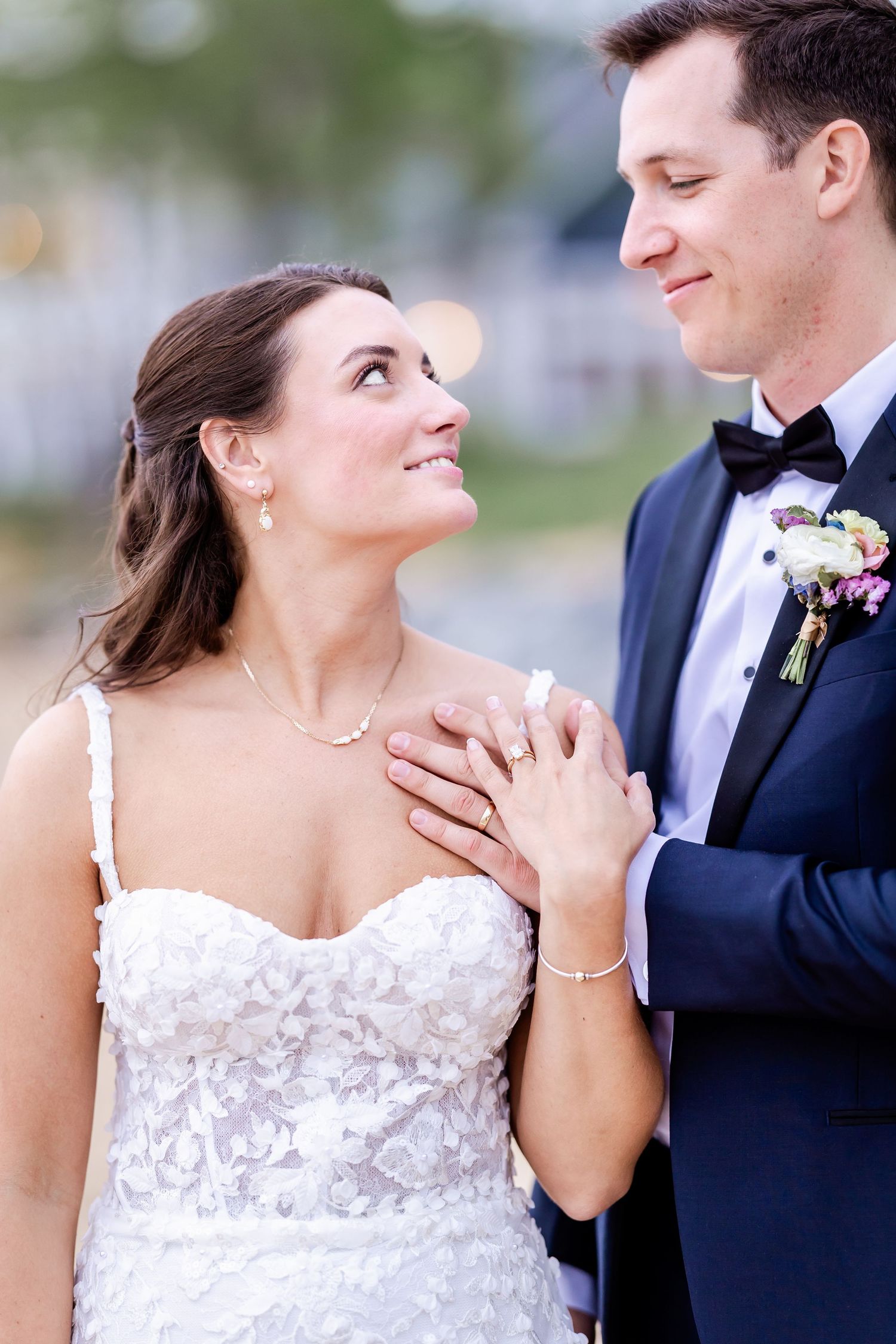 Romantic wedding portraits showing tender moments between bride in lace dress and groom in tuxedo.