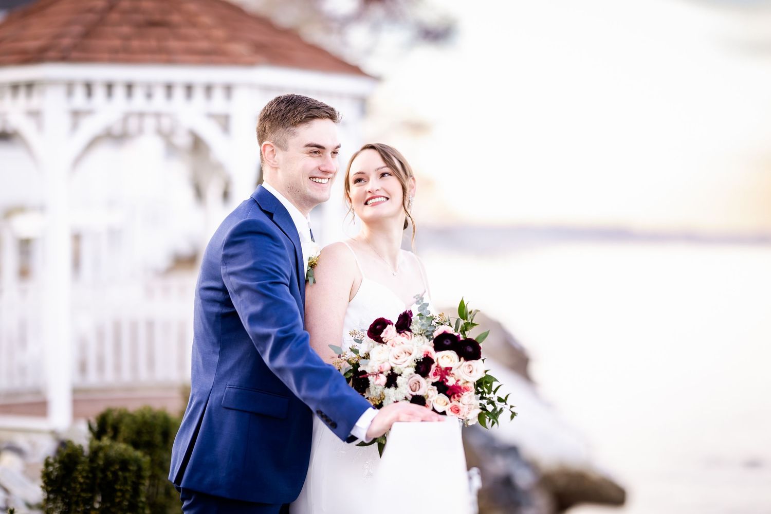 Elegant outdoor wedding photography session with couple and wedding party in formal attire.
