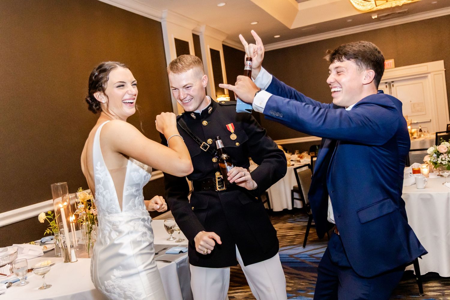 Wedding guests mingling and celebrating during reception in an elegant ballroom setting.