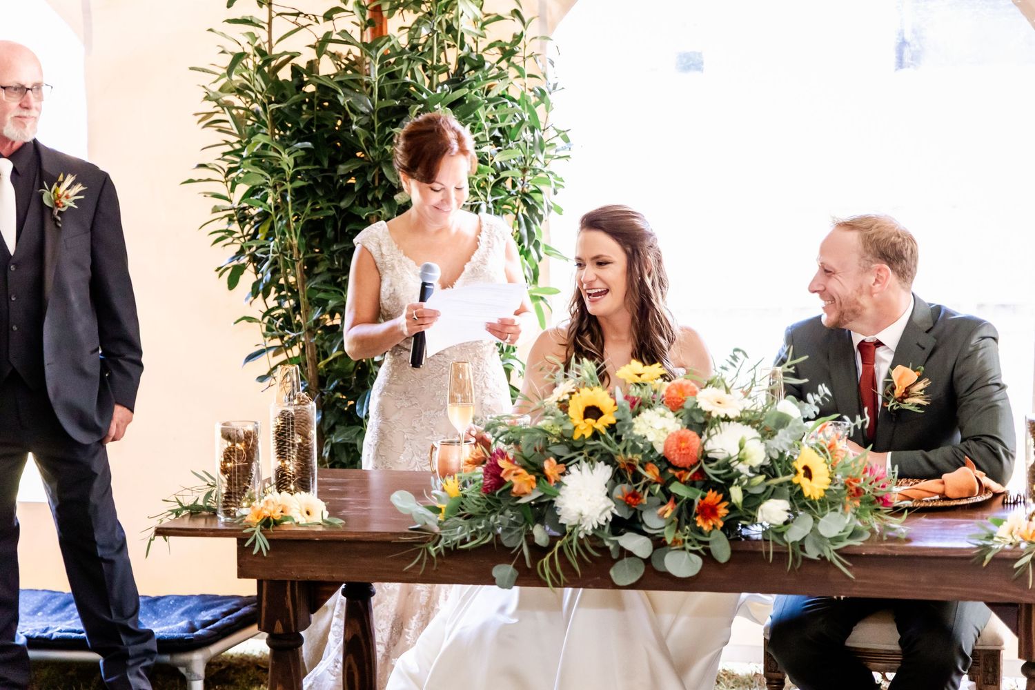 Wedding reception guests enjoying an elegant outdoor celebration with string lights and floral decorations.