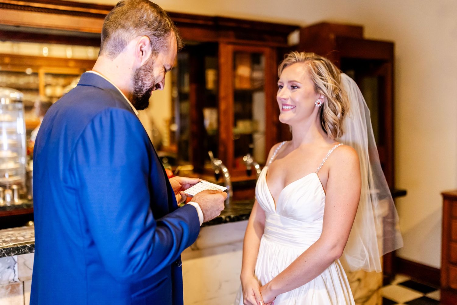 A couple exchanges vows during an intimate indoor wedding ceremony.