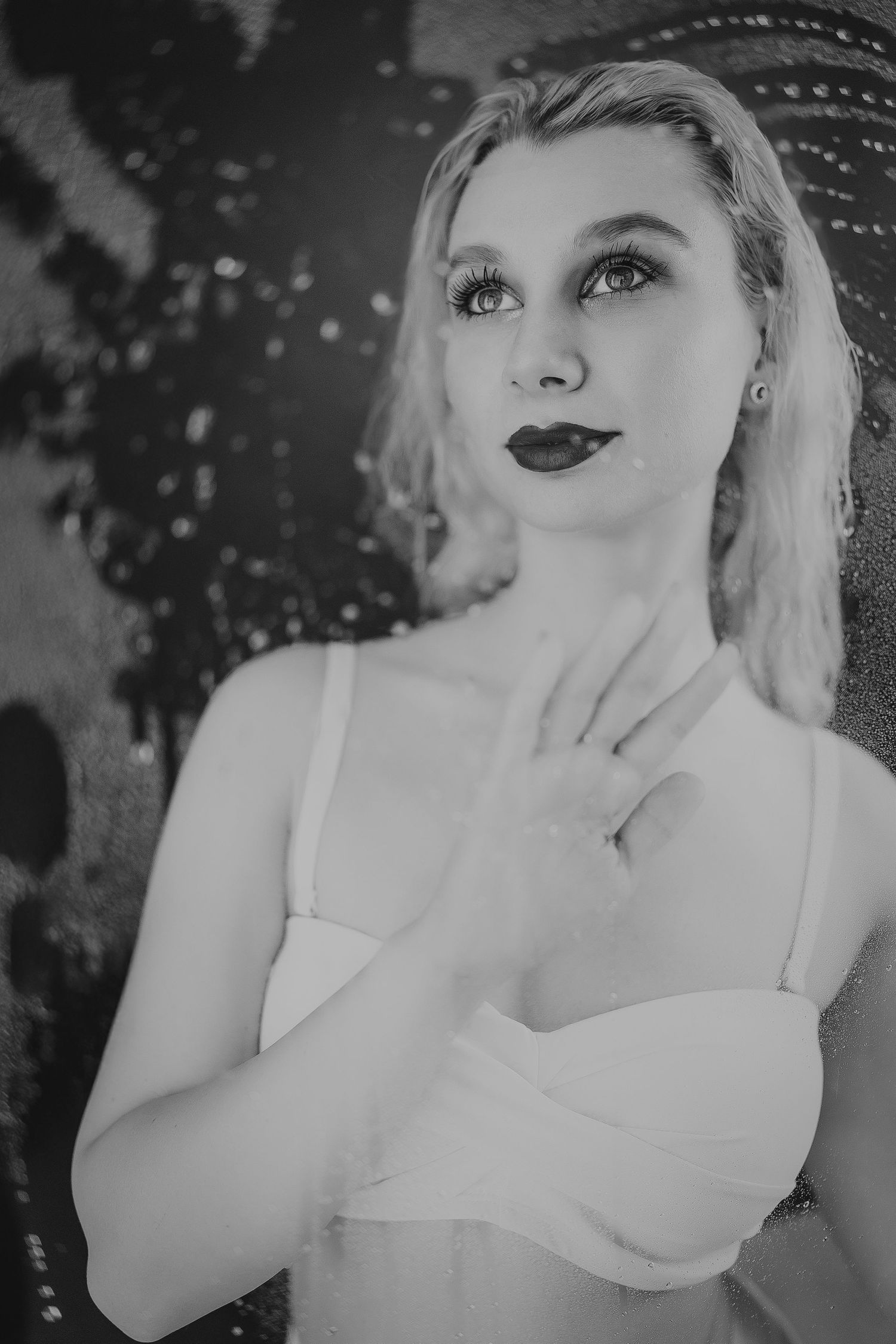 A black and white photo series showing dramatic close-up portraits of a woman in a white dress with vintage styling.
