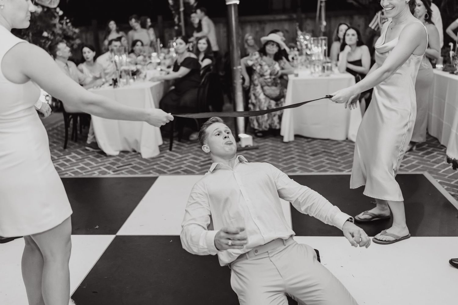Black and white photos of guests dancing and celebrating at wedding reception.