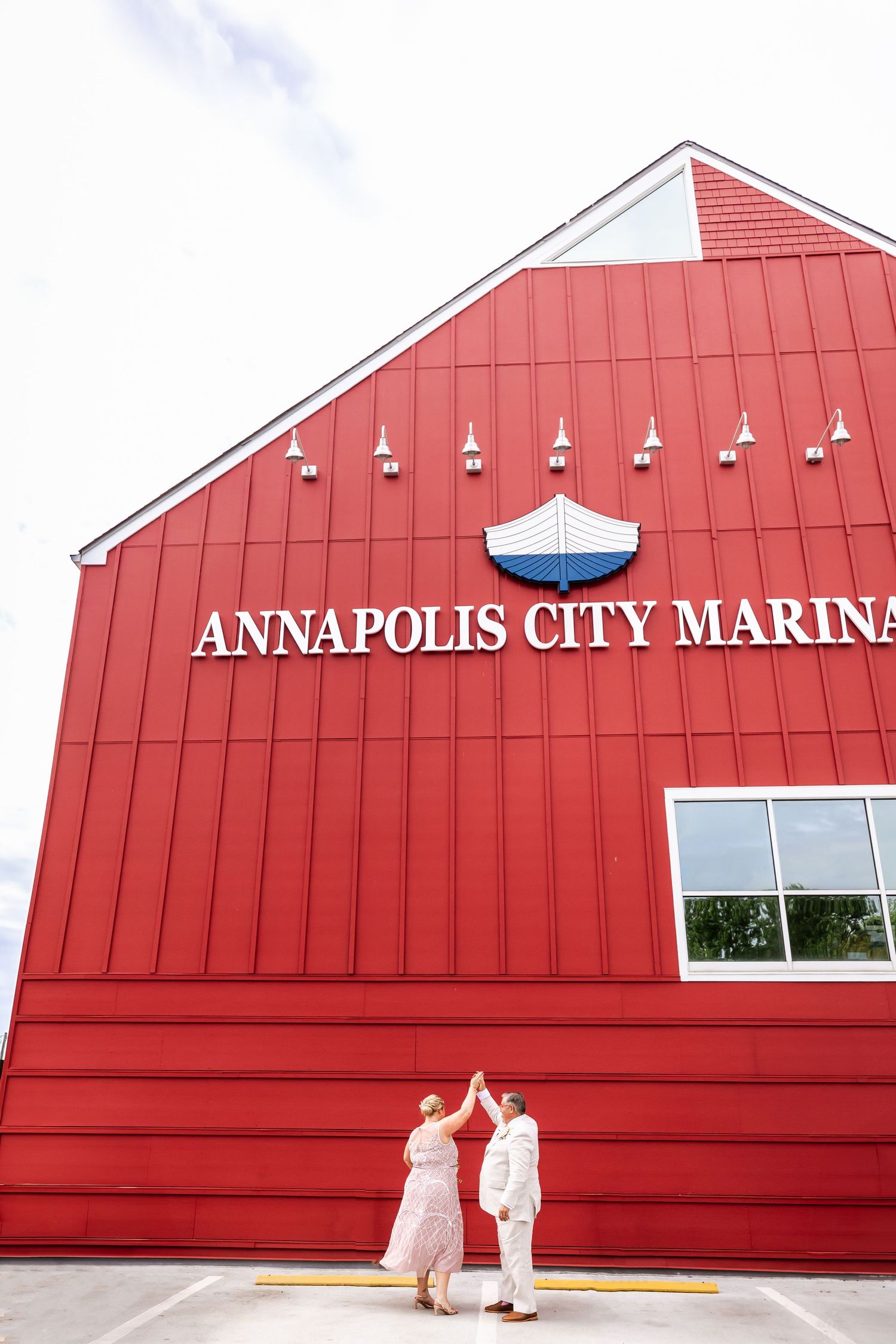 A red building with Annapolis City Marina signage and a small boat logo on its exterior.