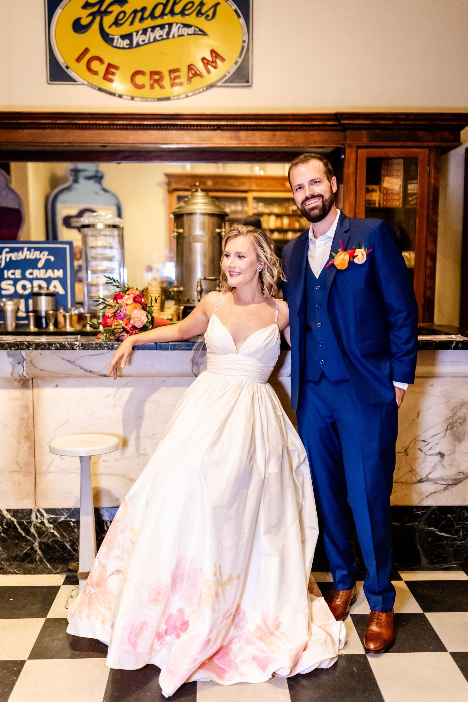 Wedding photo taken at Fendlers Ice Cream shop with vintage decor and checkered floor.