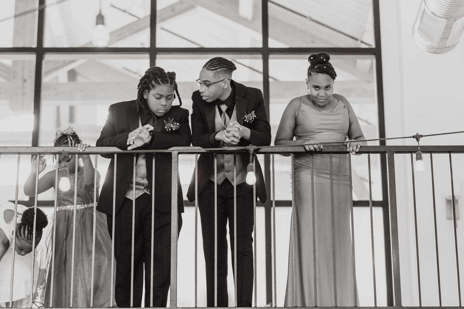 People conversing on a balcony in classic black and white photography.