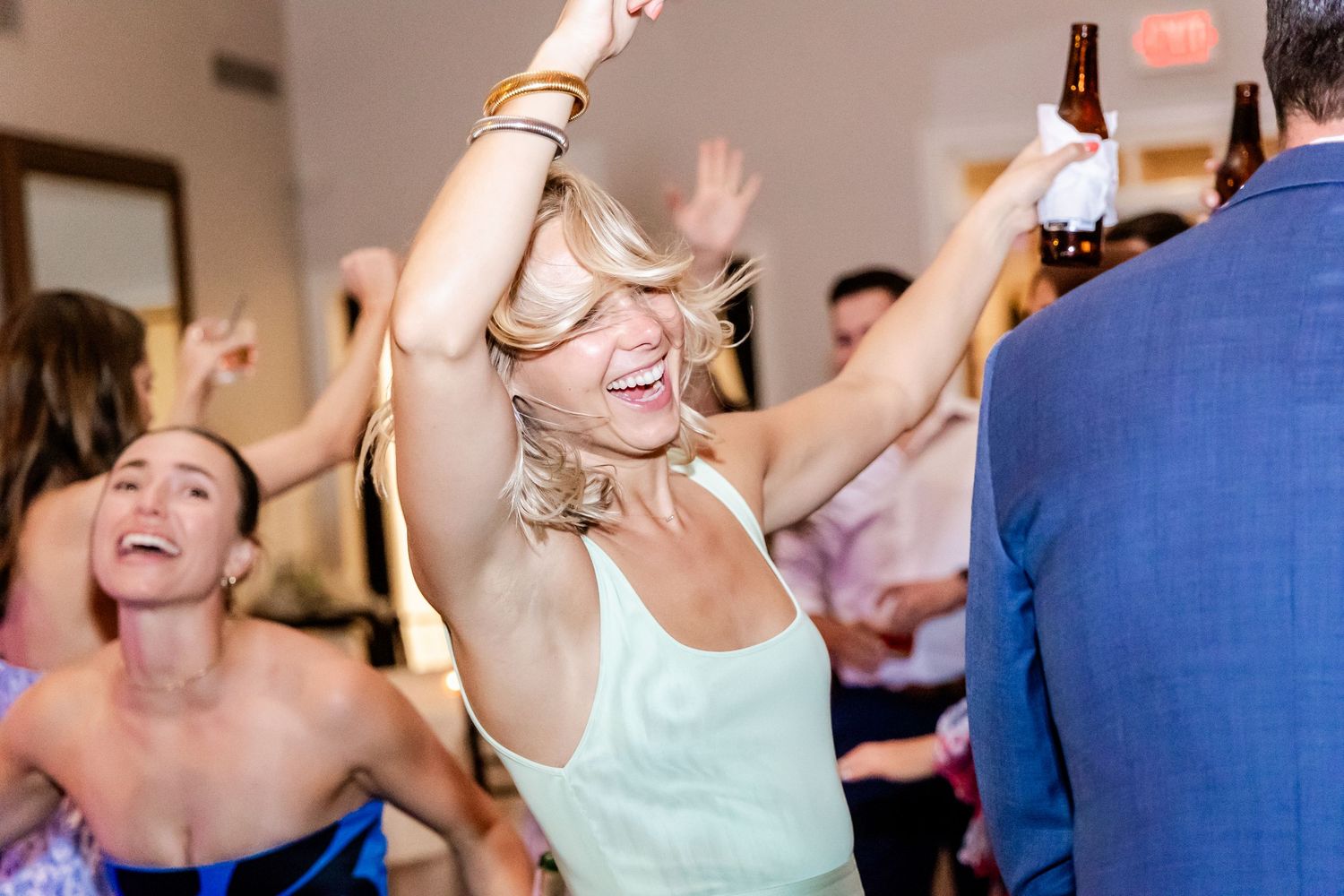 Energetic dancing and celebration at a wedding reception with joyful party atmosphere.