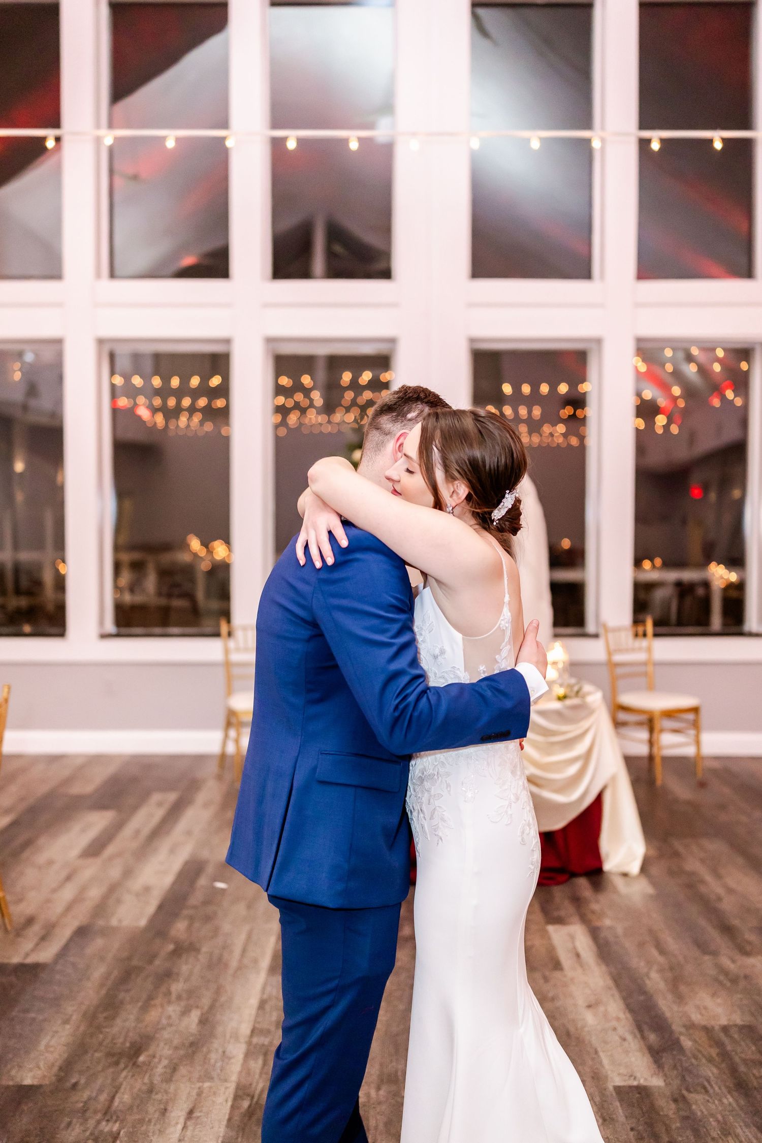 Sequence of romantic first dance moments in a bright venue with string lights and wooden floors.