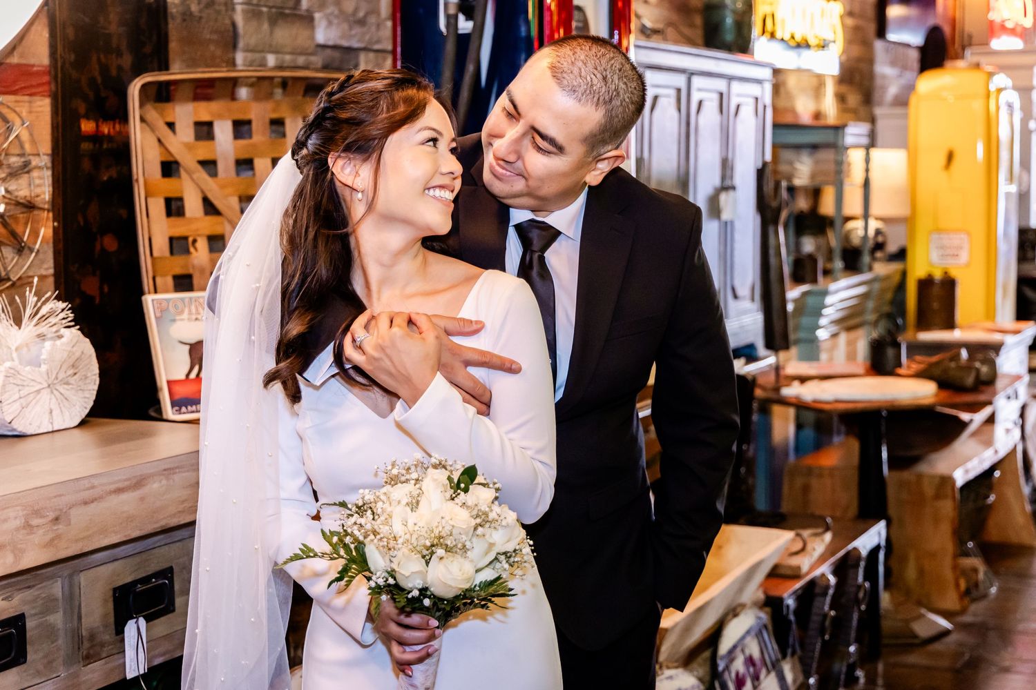 A happy couple shares a joyful moment in a rustic restaurant setting.