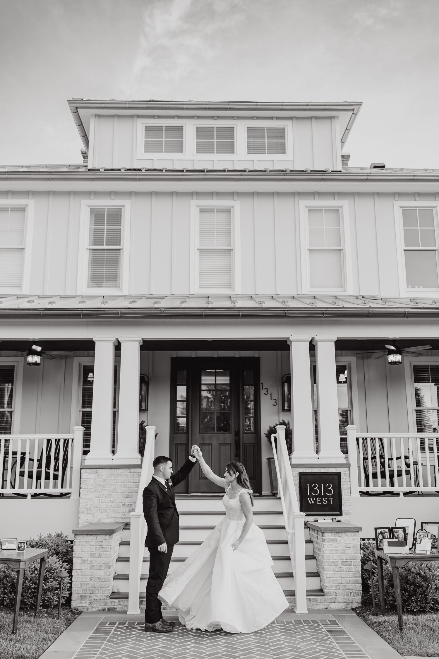 Black and white photos of a couple in wedding attire posing outside a white colonial-style building.