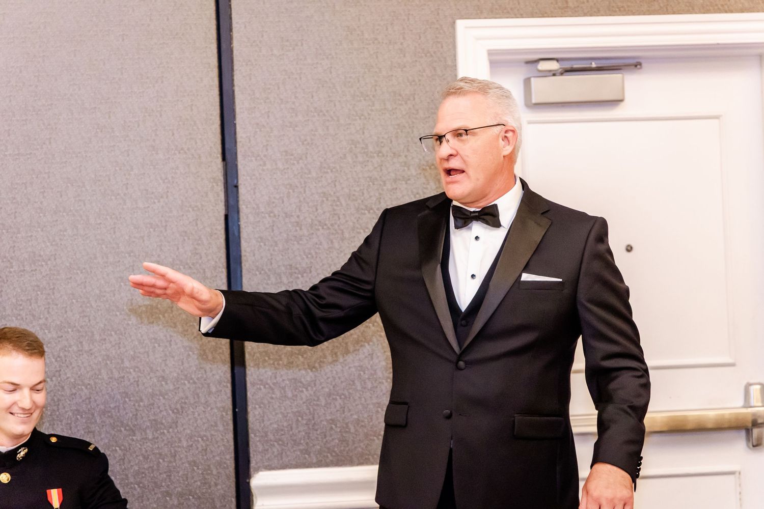Wedding guests enjoying formal celebrations in an elegant indoor venue with white walls.