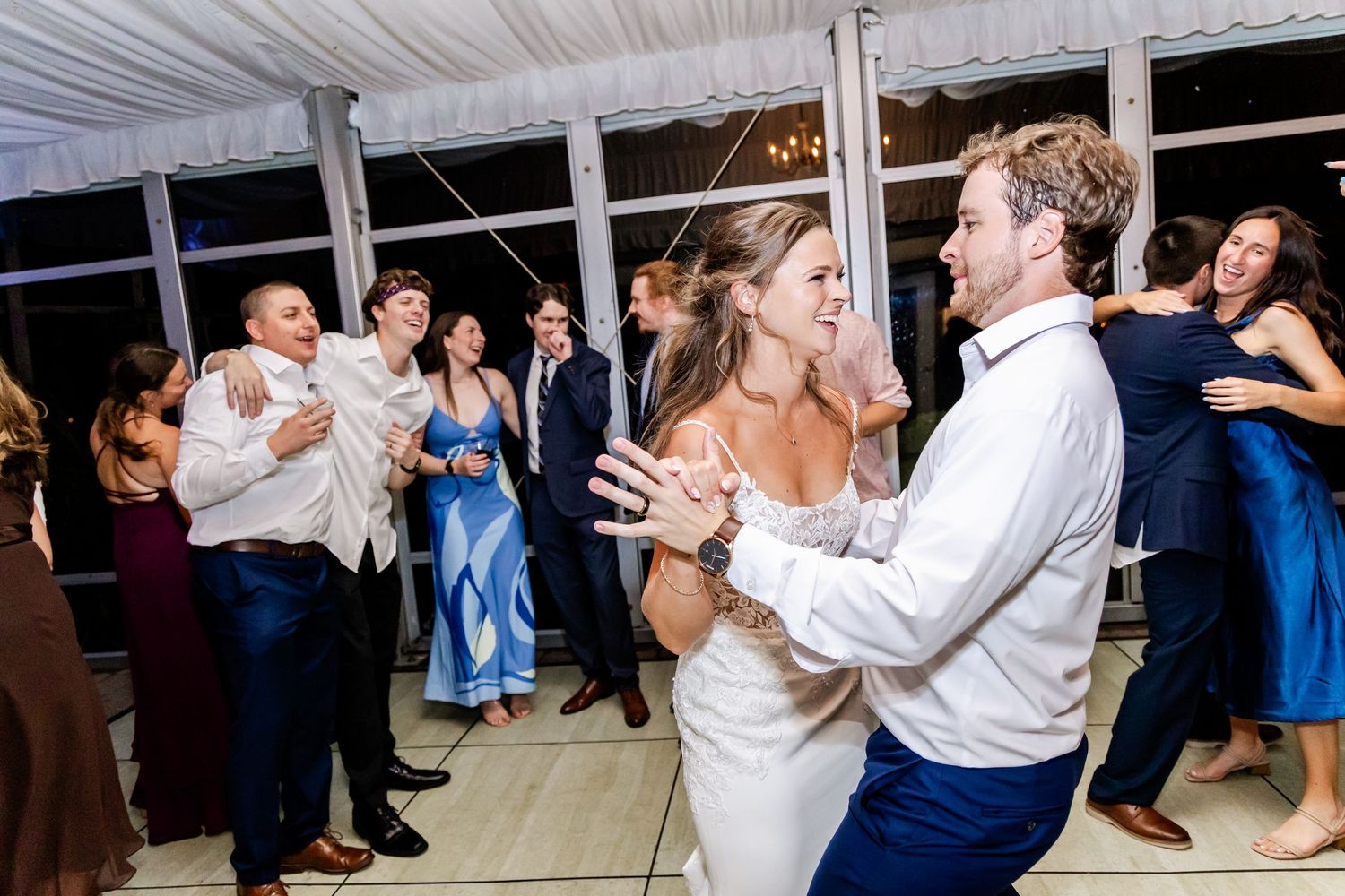 Couples dancing together during wedding reception in elegantly decorated venue space.