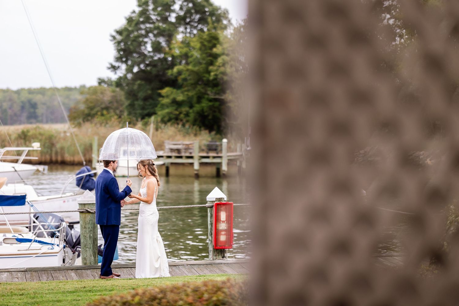 Scenic marina wedding photography with boats and docks in the background.