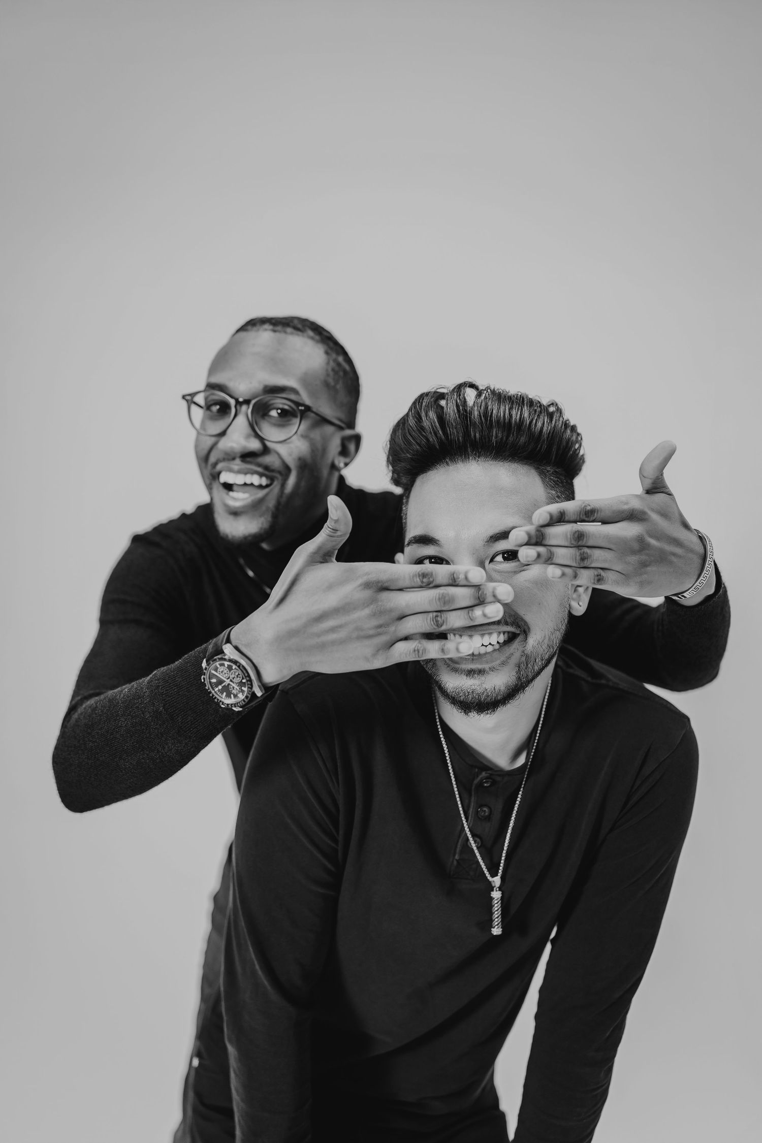 Black and white photo series captures playful moments between two friends making silly expressions.