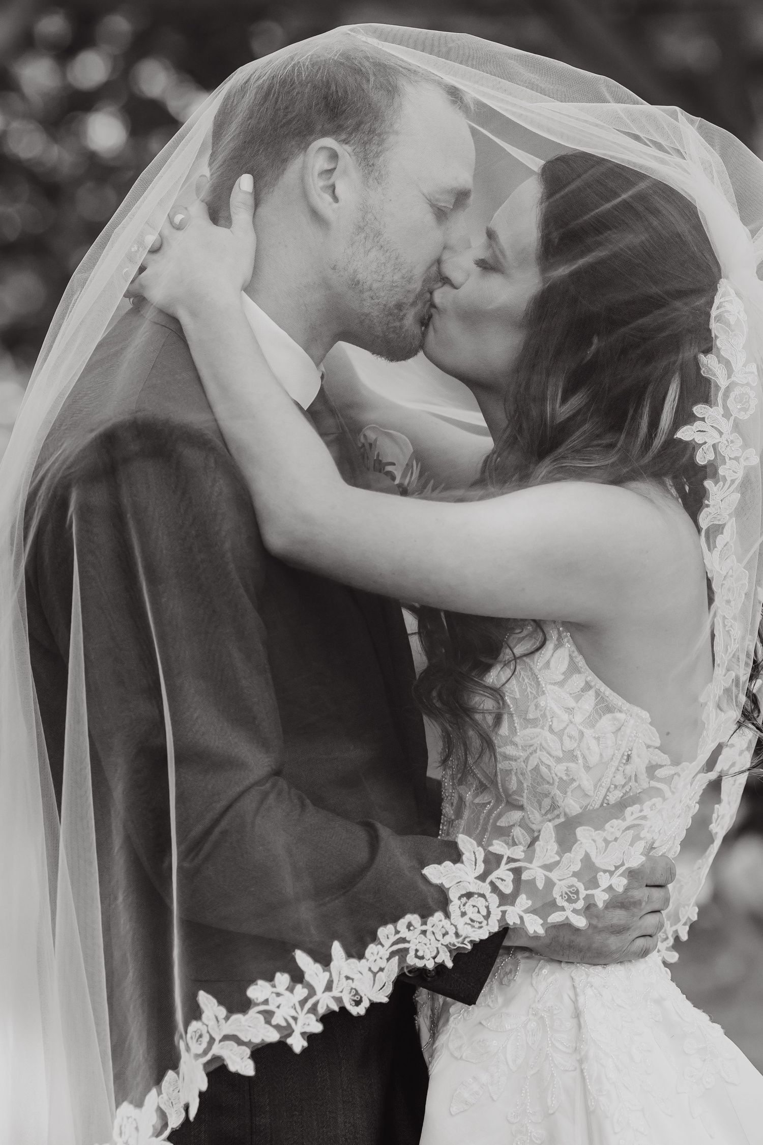 Black and white romantic wedding portraits showing intimate moments between bride and groom.
