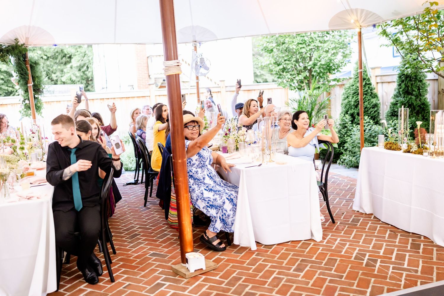 Brick patio decorated with tables and chairs for an elegant outdoor event.