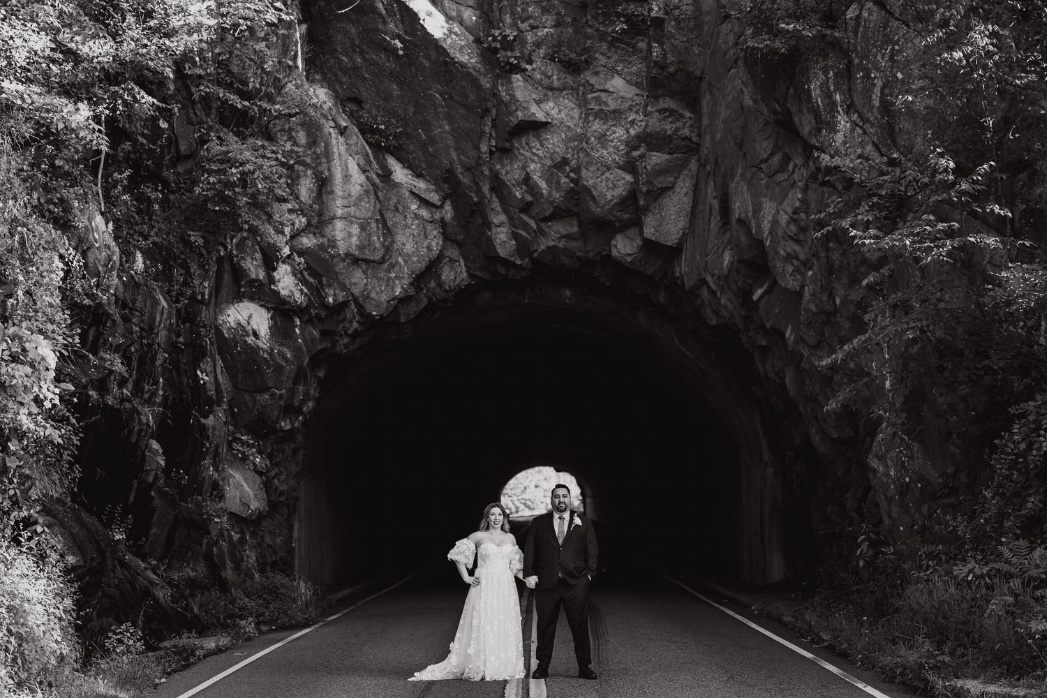 Wedding couple portraits in dramatic cave and tunnel settings with natural rock formations.