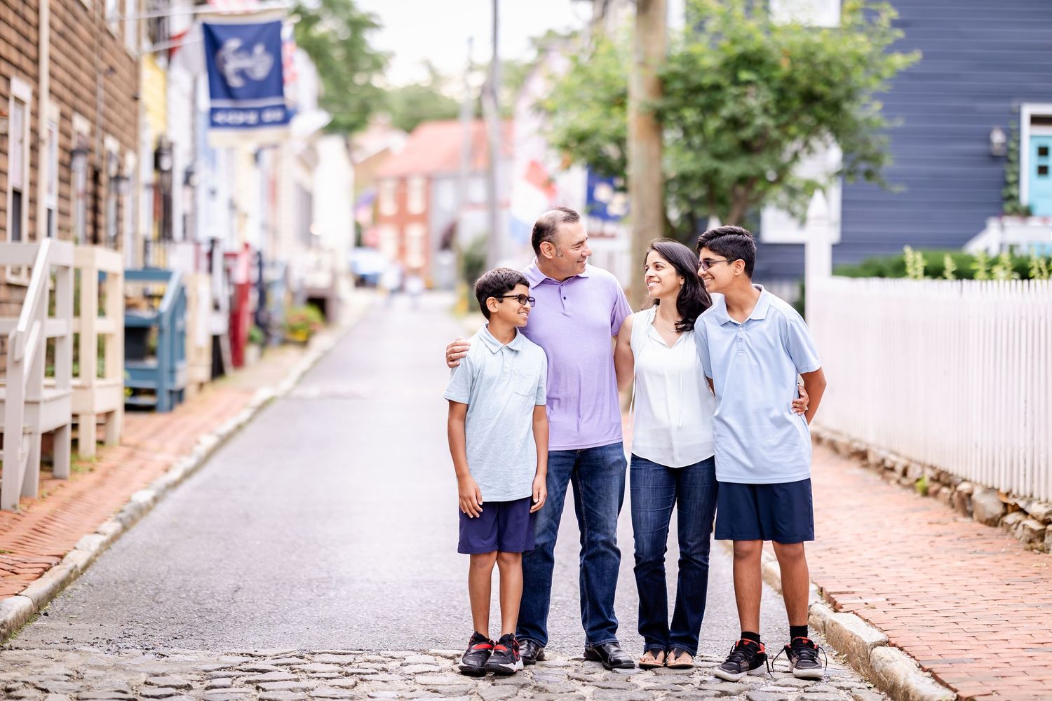 Group of people walking together along a charming brick-paved street lined with historic buildings in Boston.