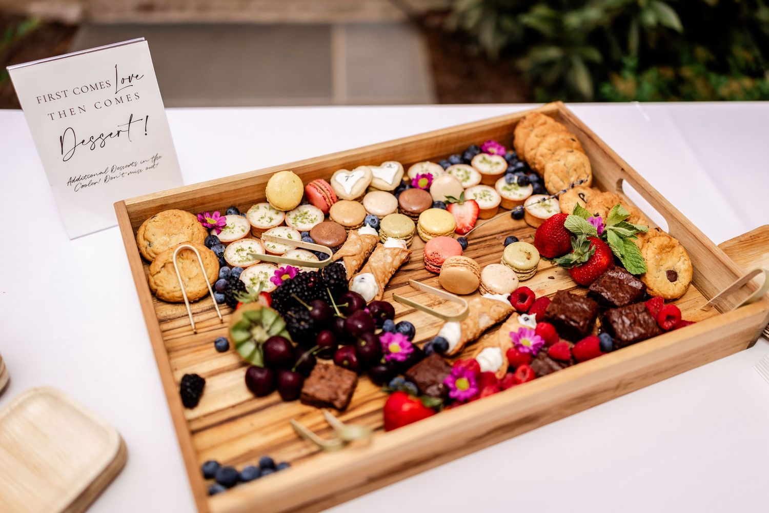 Wooden charcuterie boards filled with assorted cheeses, meats and fruits.