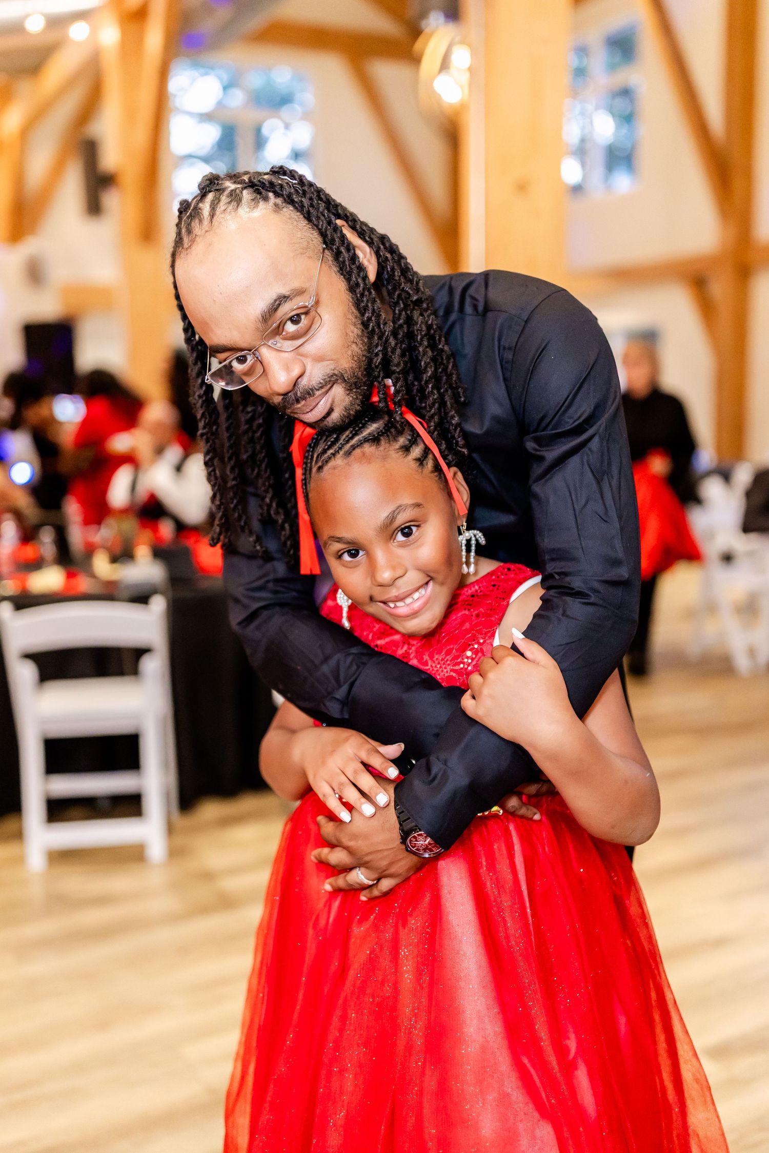 A touching moment between two guests in formal attire at a wedding reception.
