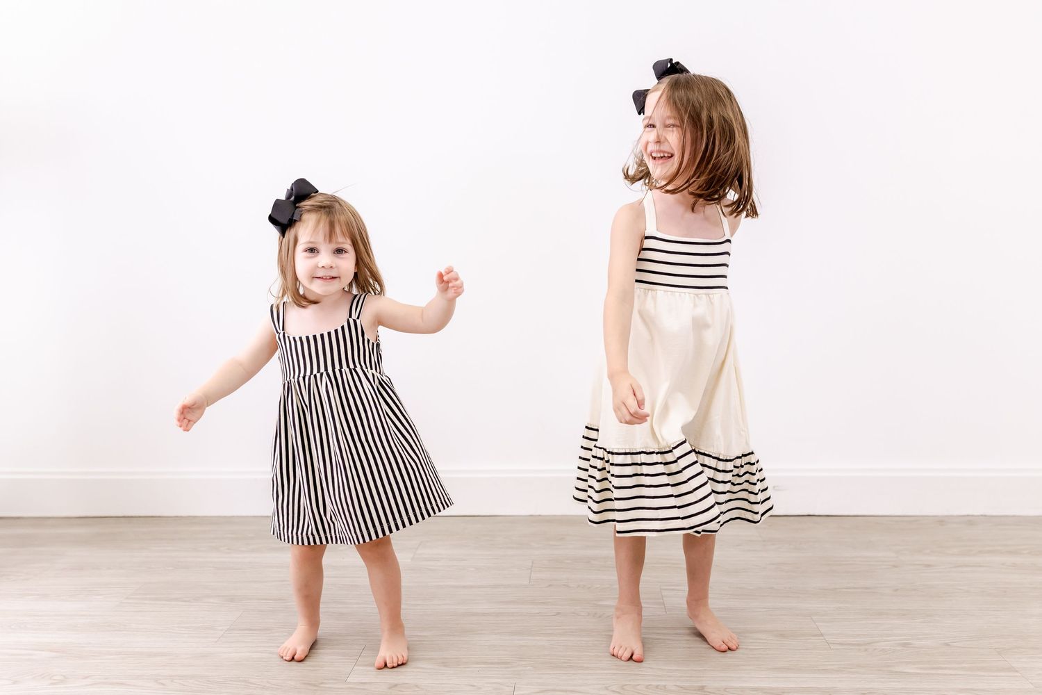 A set of photos showing children in black and white striped dresses dancing and playing on a white background.