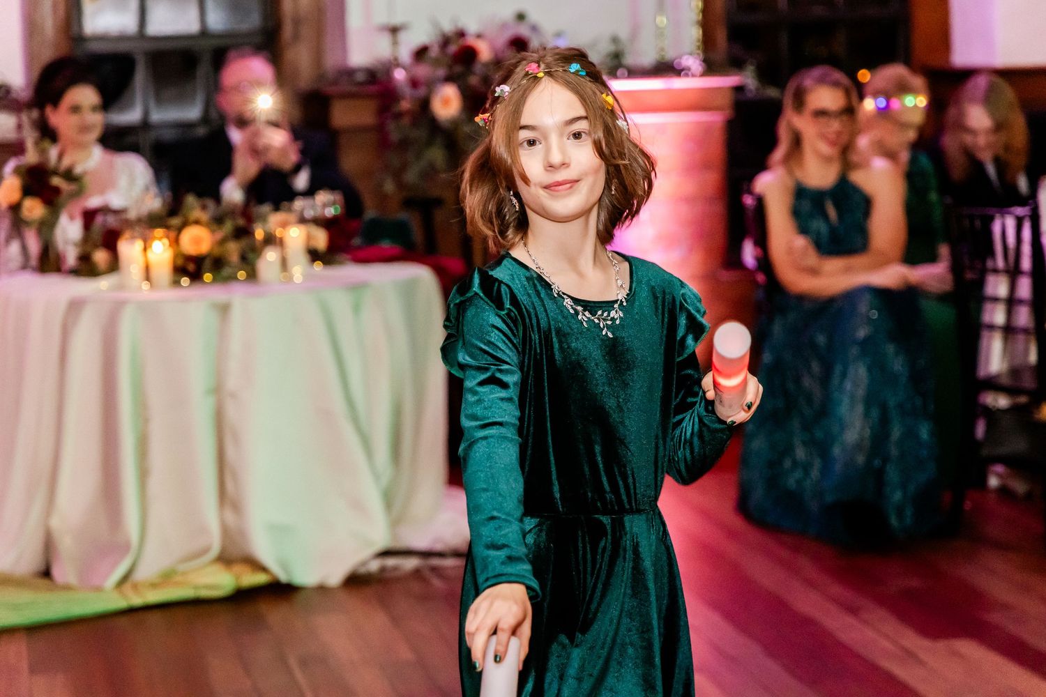 Guests in formal attire dancing and celebrating at an evening event.