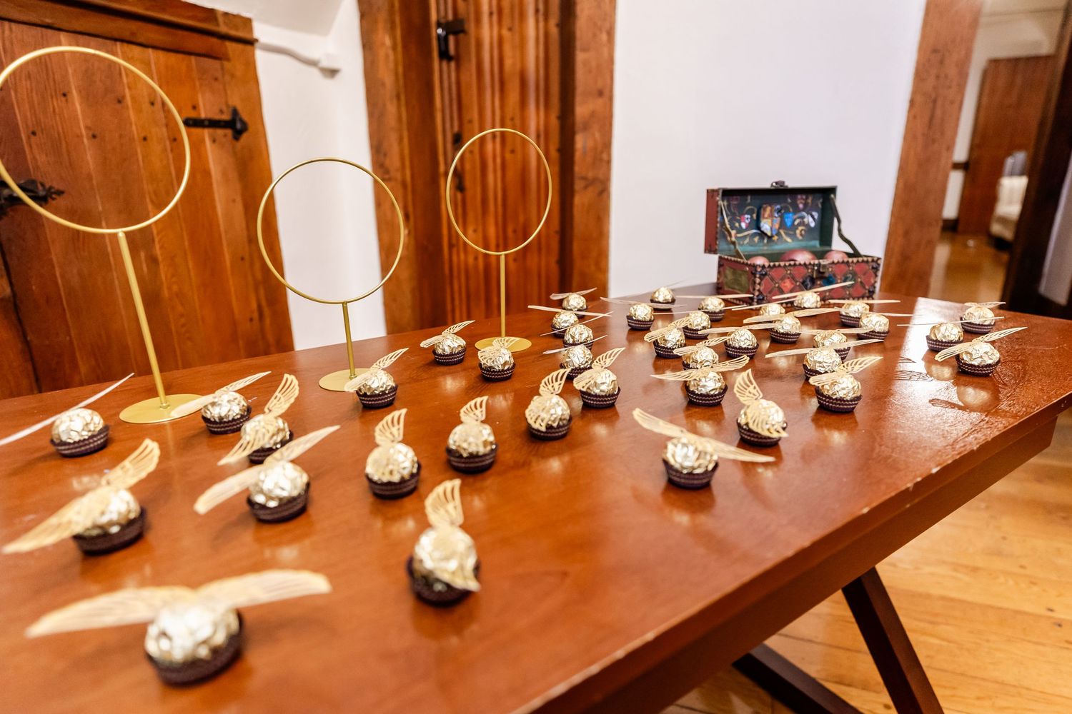 Small decorative objects and hoops arranged on a wooden table for a special event.