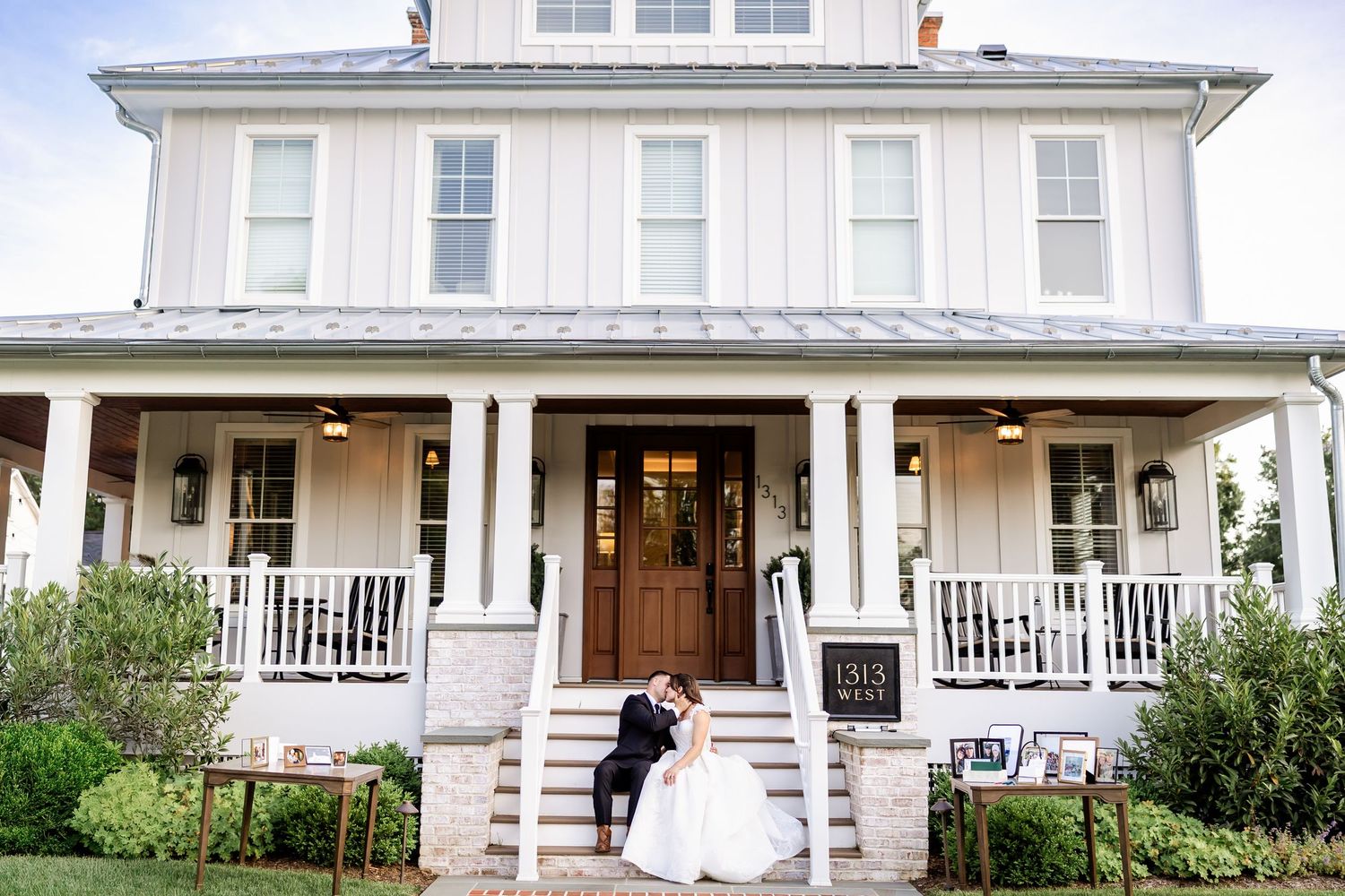 White farmhouse style venue with wrap-around porch and classic colonial architecture.