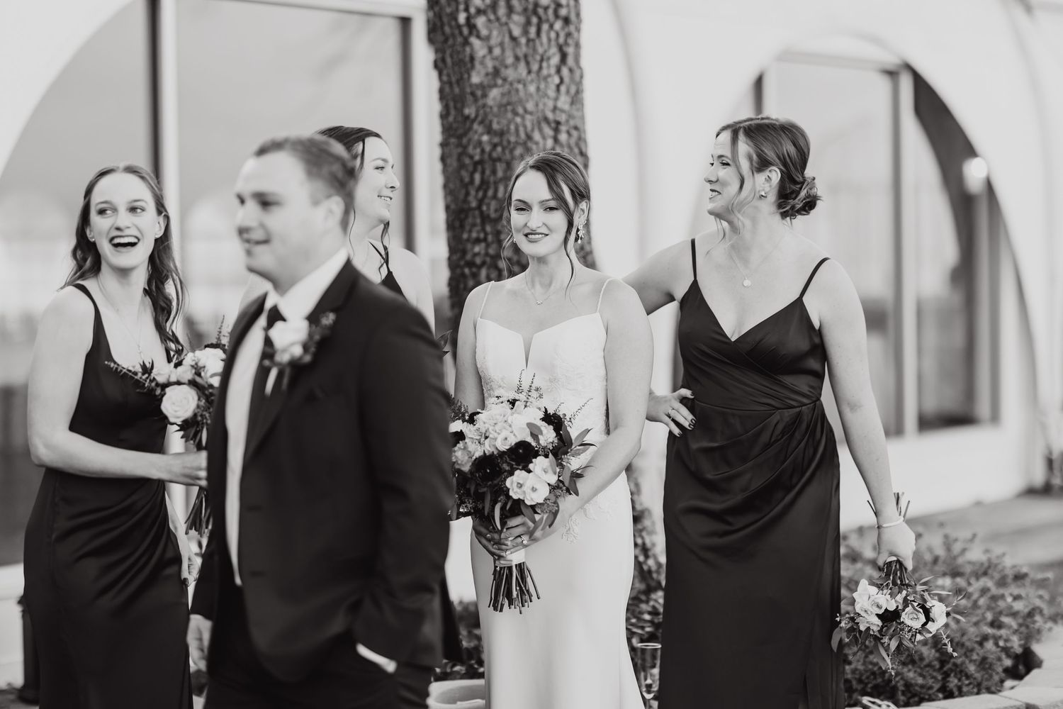 Black and white wedding photos showing joyful moments between couples and guests during an elegant celebration.