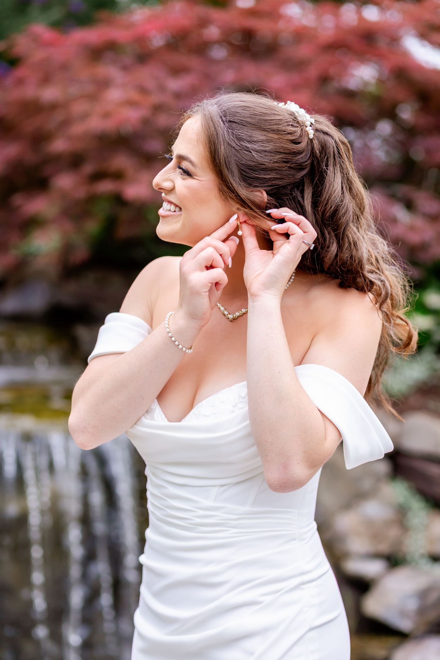 A series of candid moments showing a bride putting on earrings in a white dress against a blurred pink background.