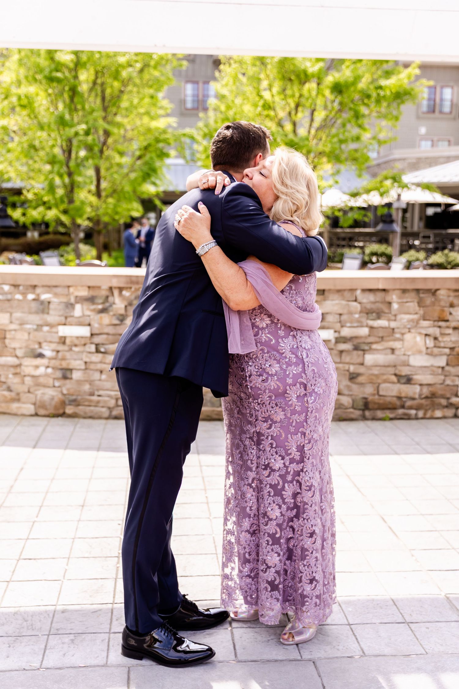 Couple shares intimate dance moment outdoors during wedding celebration.