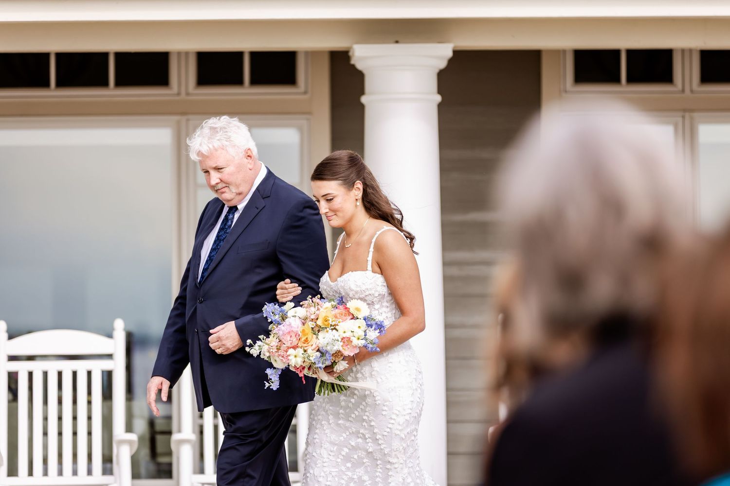 Intimate outdoor wedding ceremony moments captured on a white columned porch.