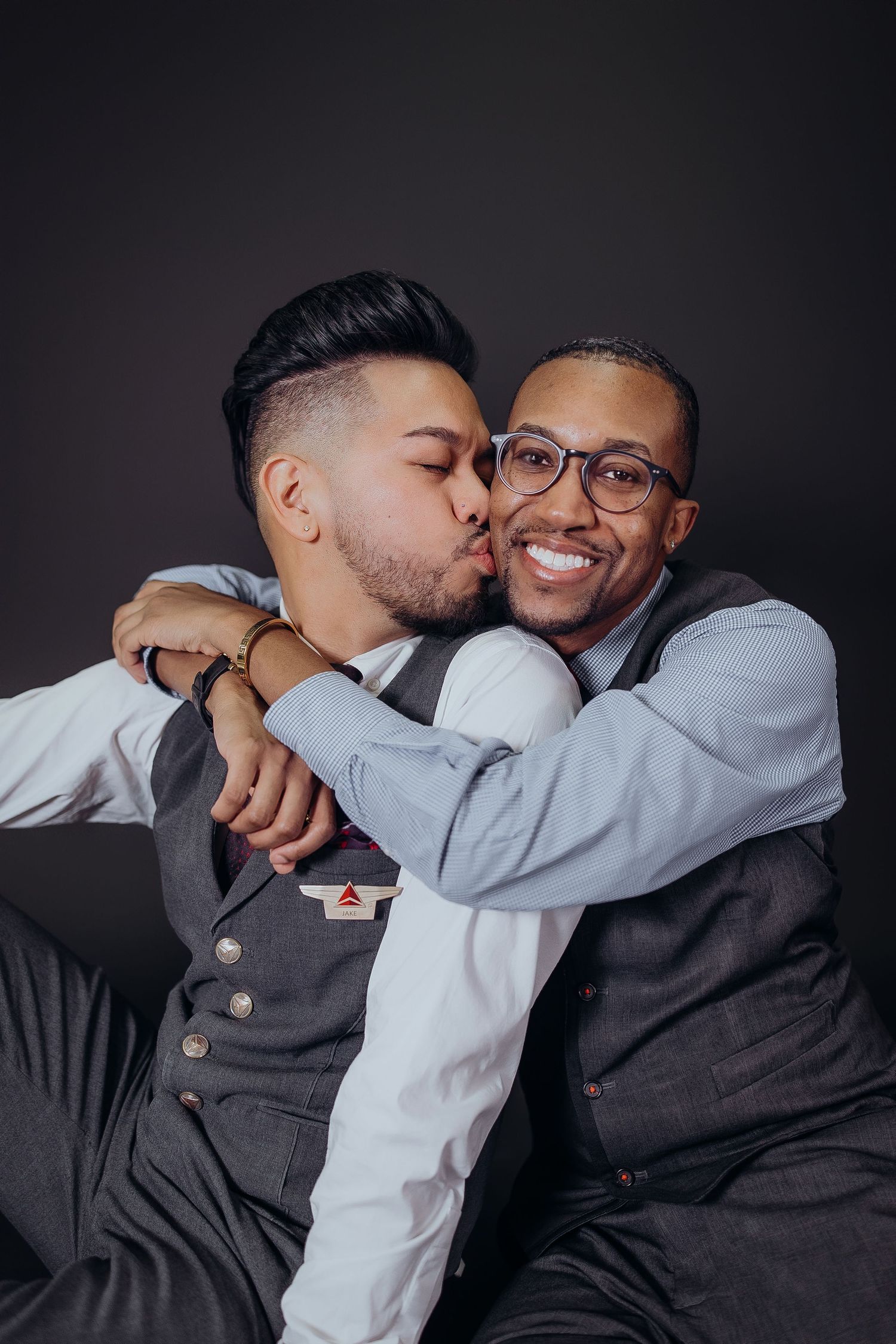 Emotional portrait series showing tender moments against dark backdrop.