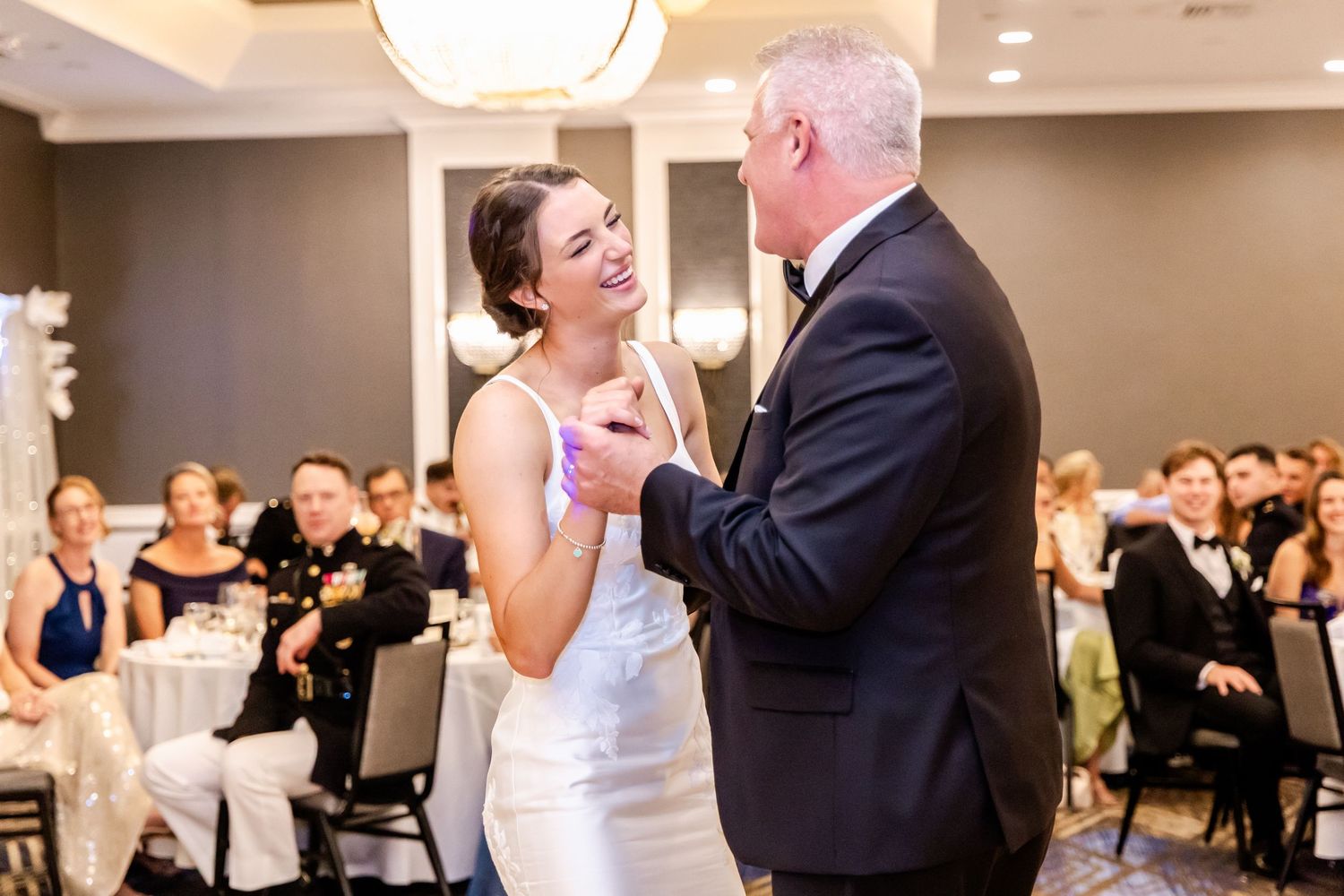 Elegant wedding reception venue with modern lighting and formal table settings.