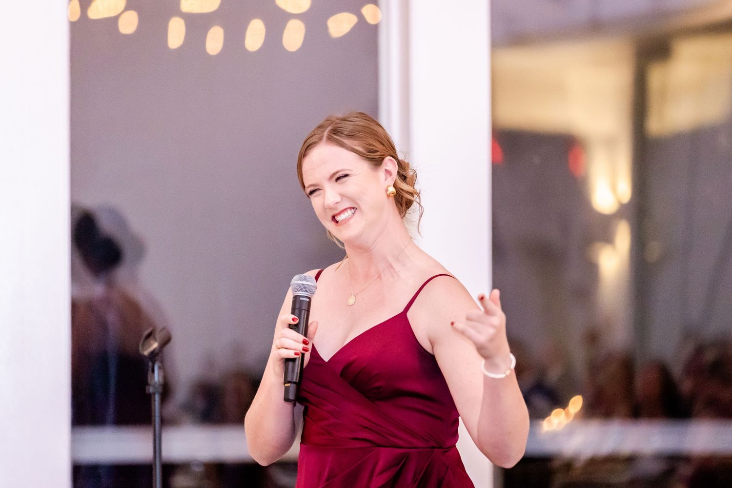 Reception moments showing guests in burgundy attire enjoying celebrations in a bright indoor space.