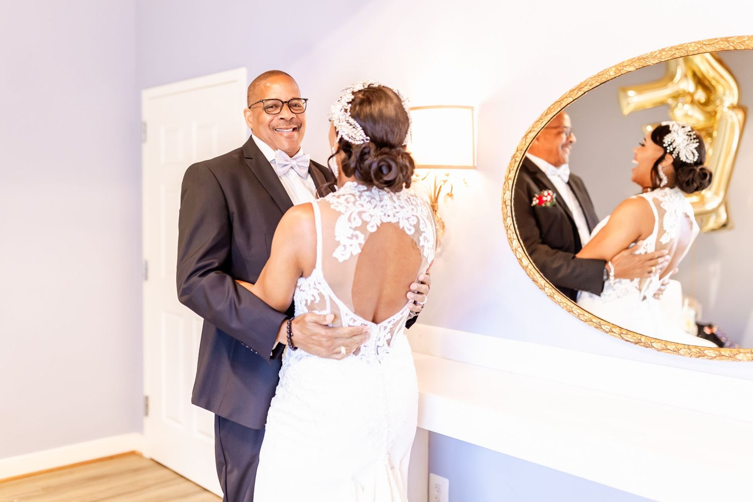 Wedding couple reflected in elegant mirror during intimate indoor moment.