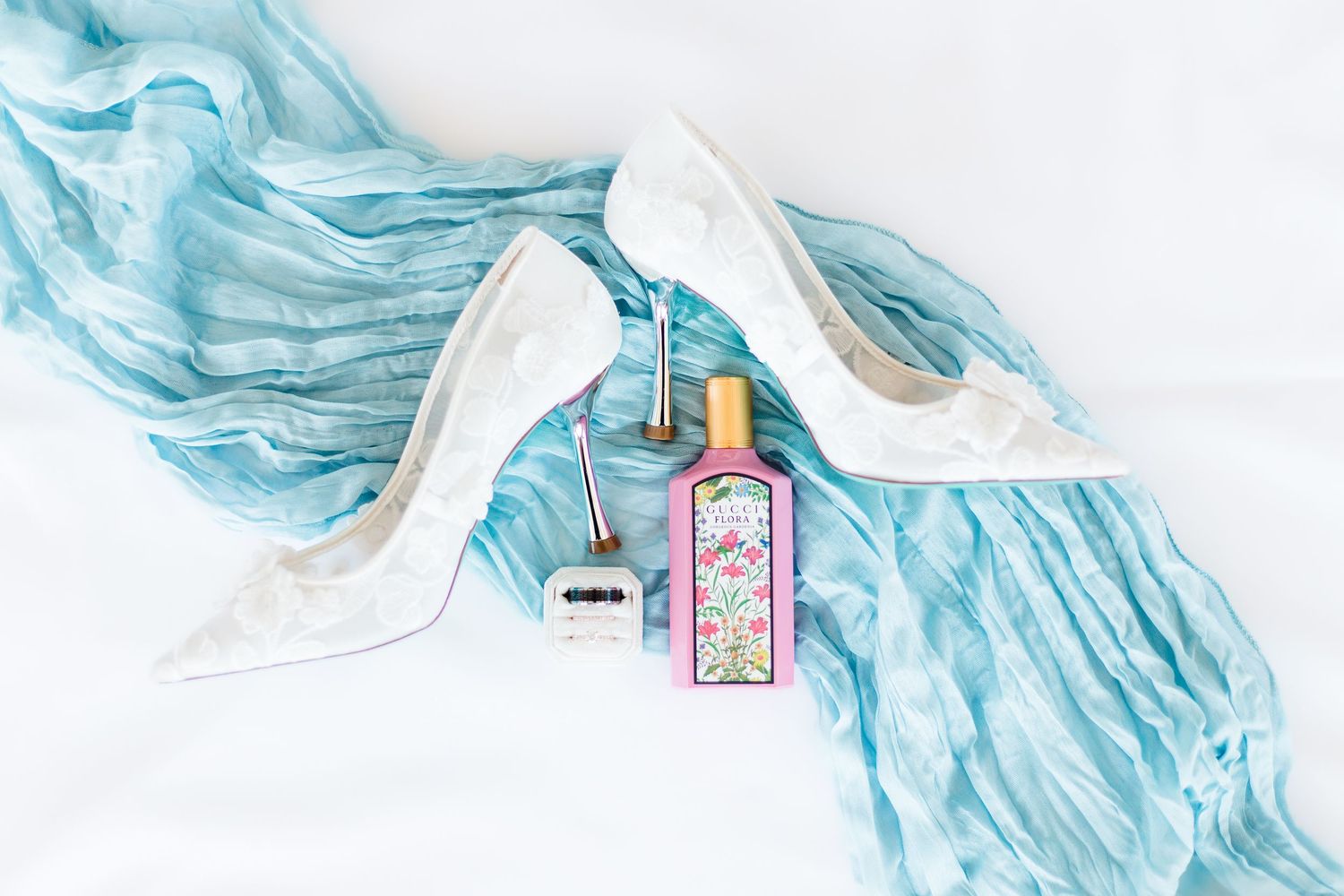 Light blue decorative elements and accessories arranged for wedding details.