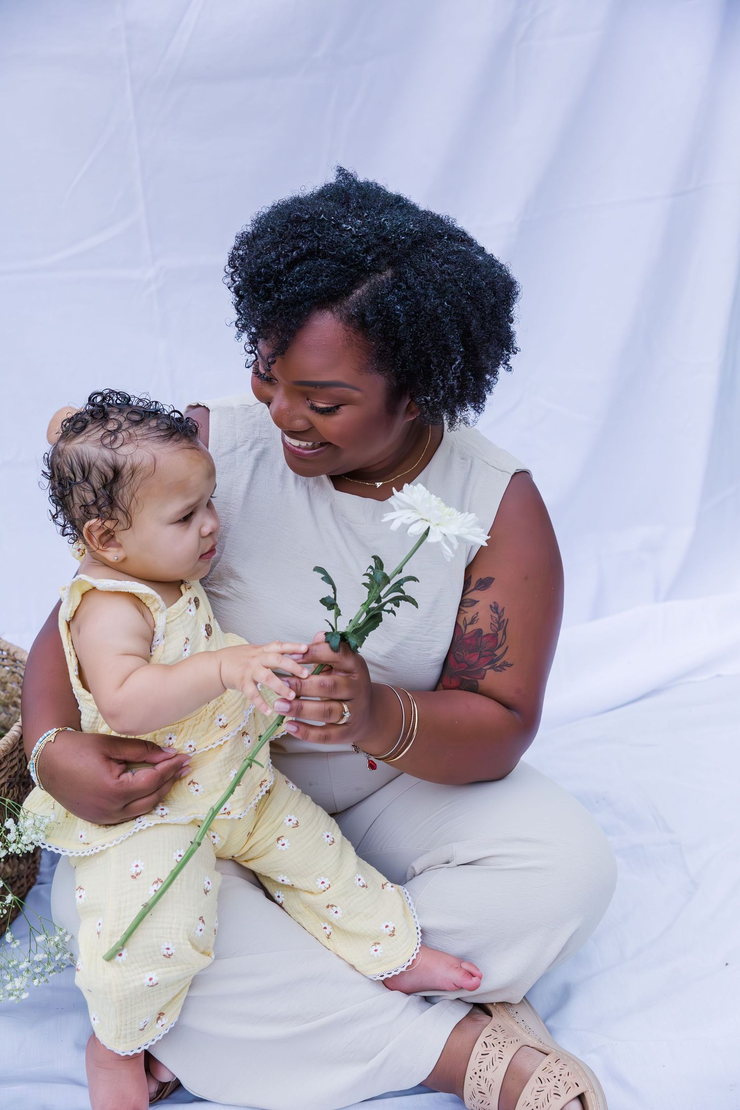 Joyful studio portraits with delicate flowers and natural interactions.