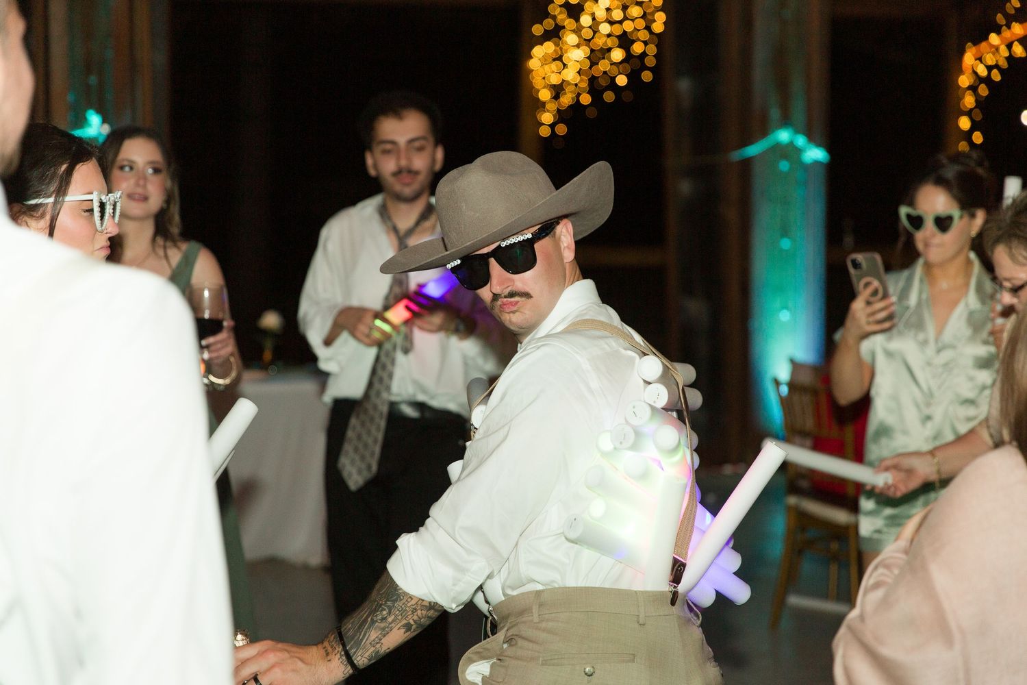 Wedding party guests wearing 3D glasses enjoy a unique entertainment experience at an evening reception.
