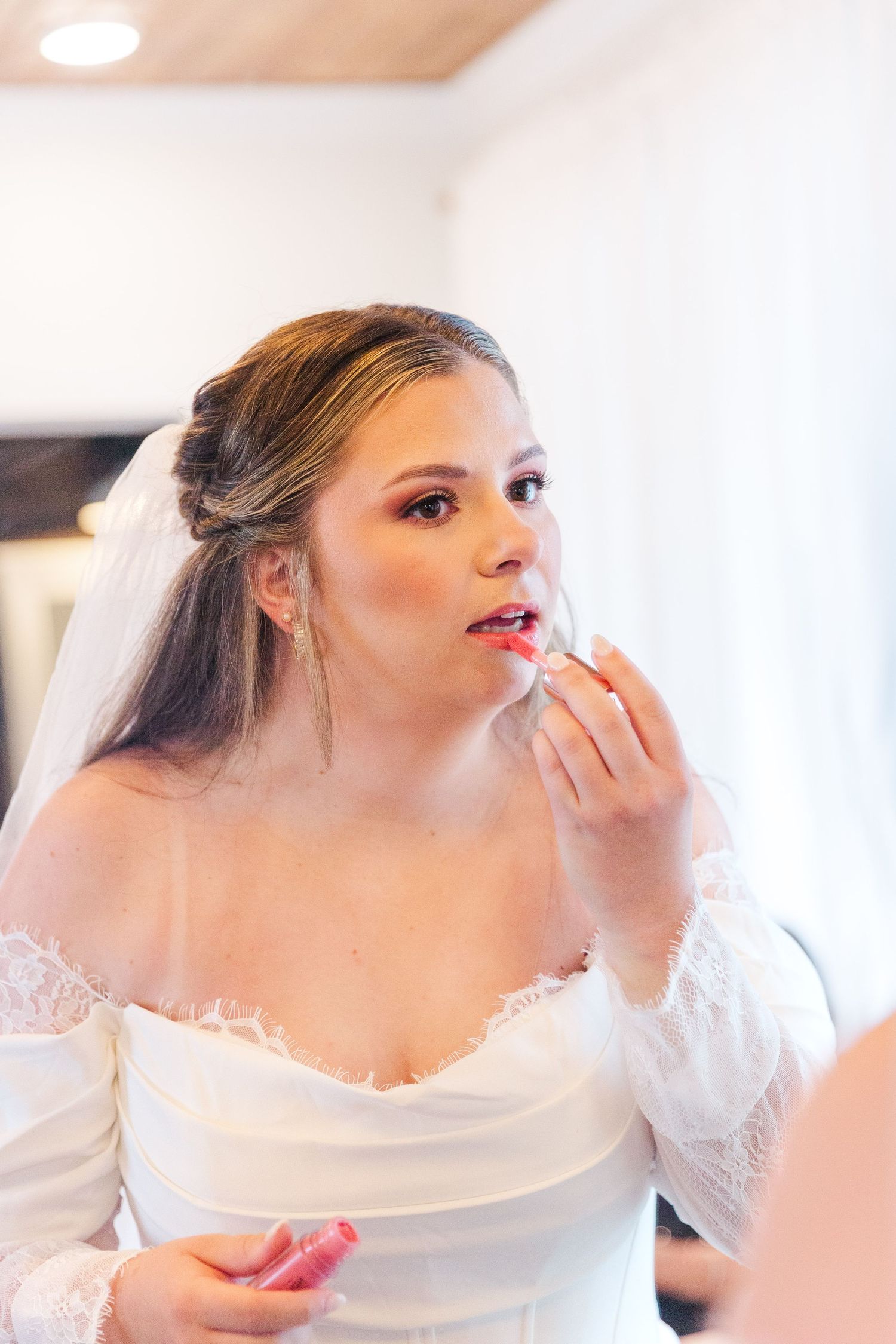 Bridal makeup preparation with soft natural lighting.