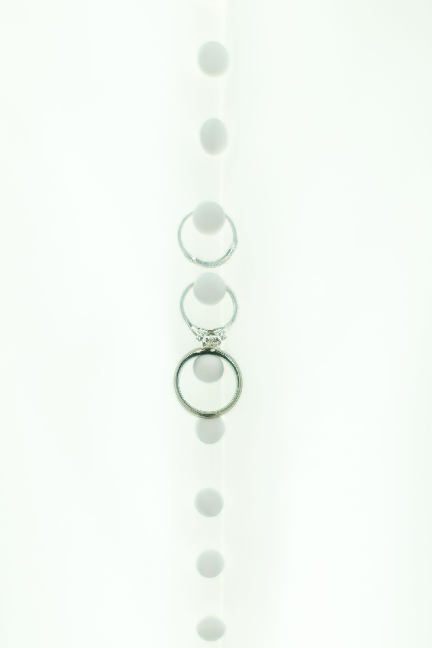 Diamond engagement ring on white background with soft bokeh effect.