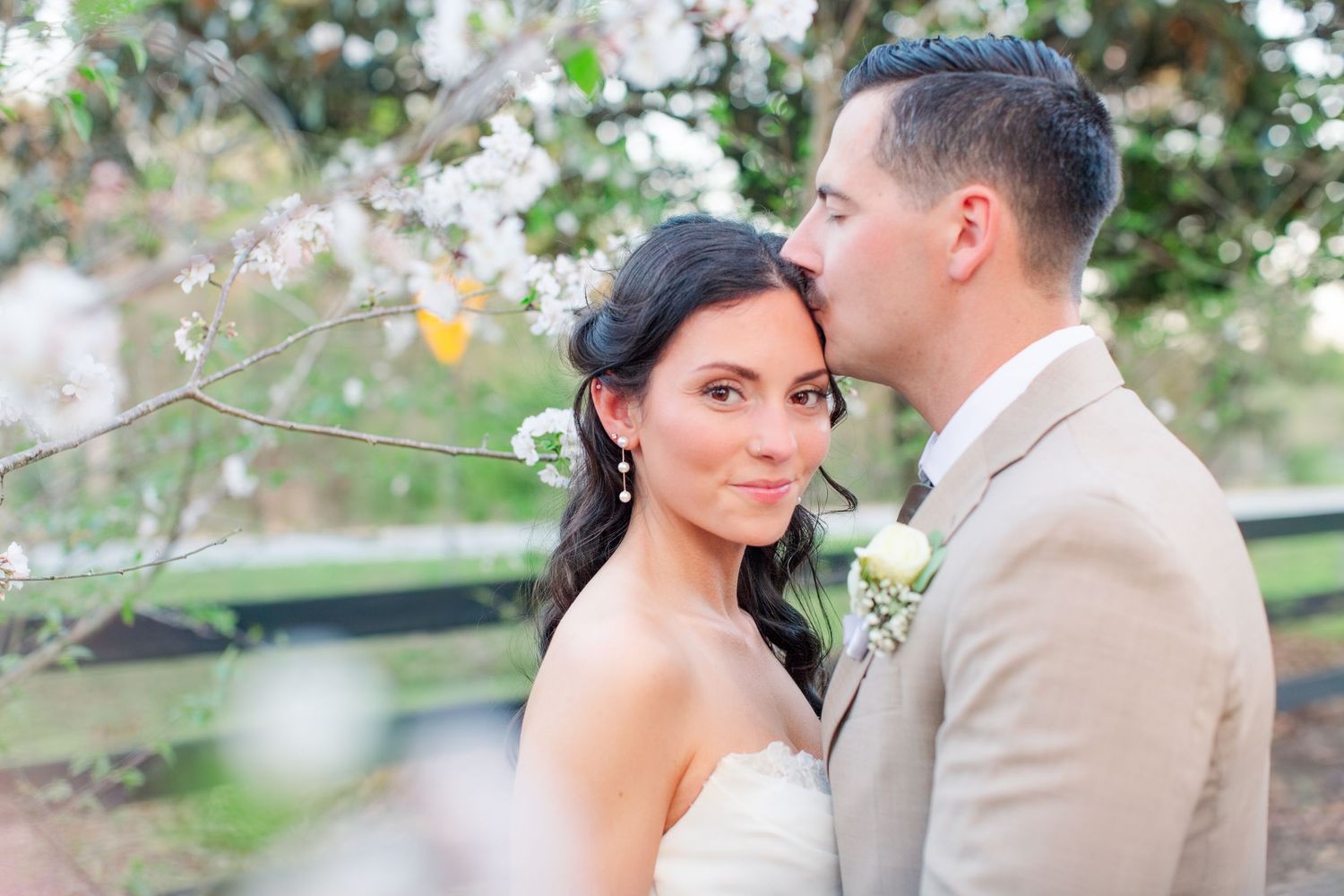 A romantic couple in wedding attire shares intimate moments in a garden setting during their special day.