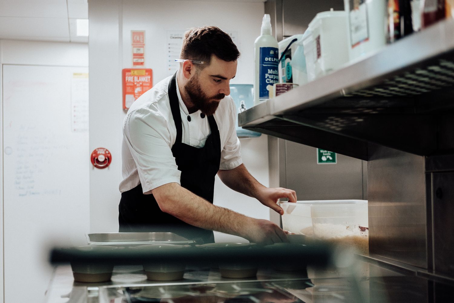 hospitality brand photography in London – chef focused on food preparation