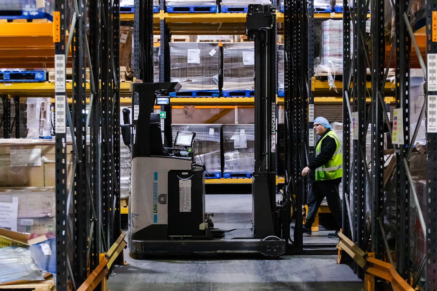 industrial photography in Kent – forklift operator moving rice pallets inside factory